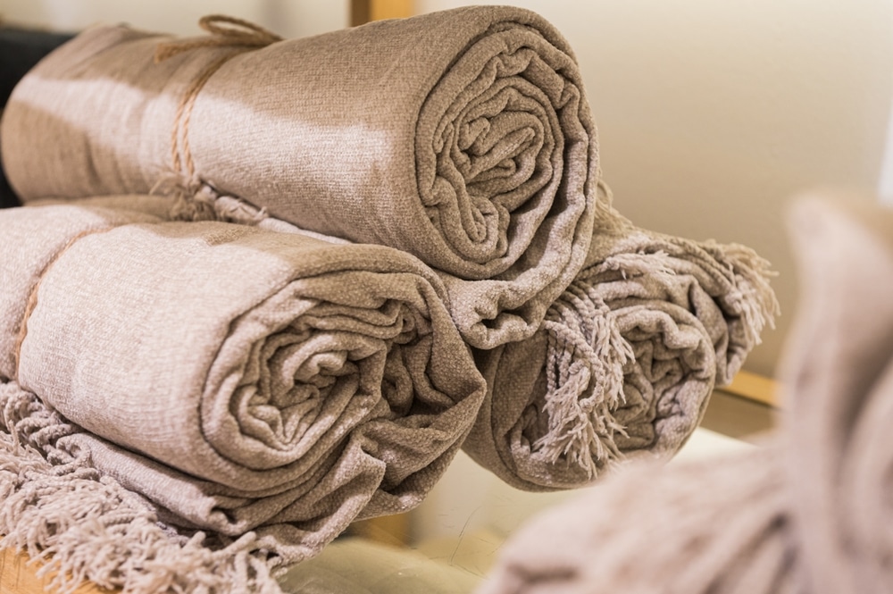 Beige natural fabrics rolled up, green interior design, natural dyes