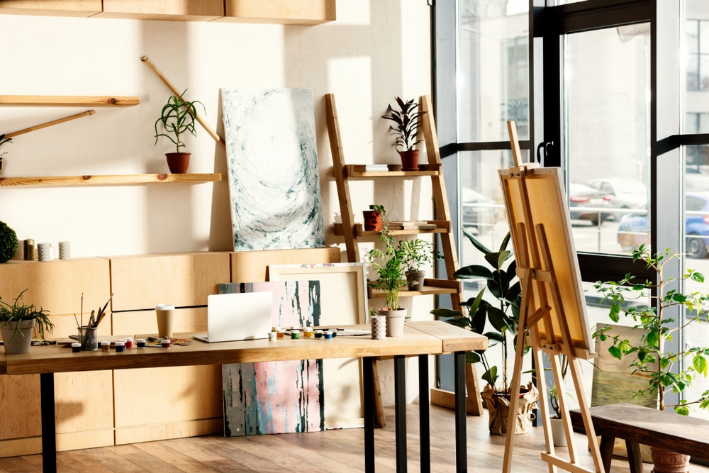 Light Filled artists studio with window onto street, standing easels, workspace and storage space