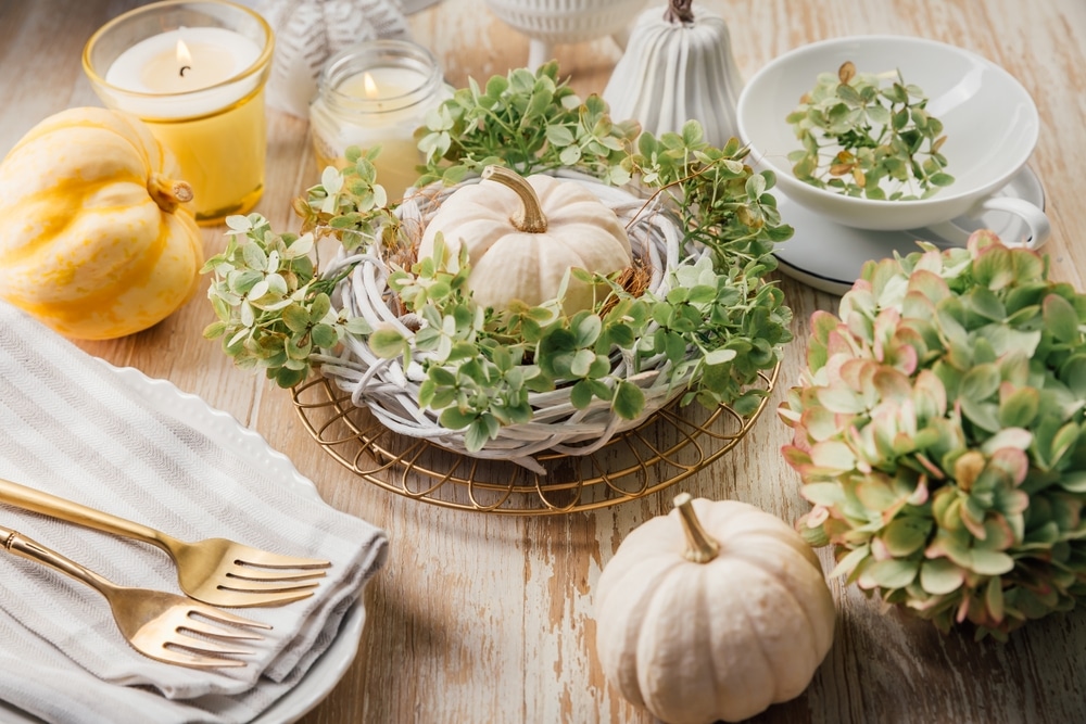 Beautiful holiday table setting with pumpkin and green wreath